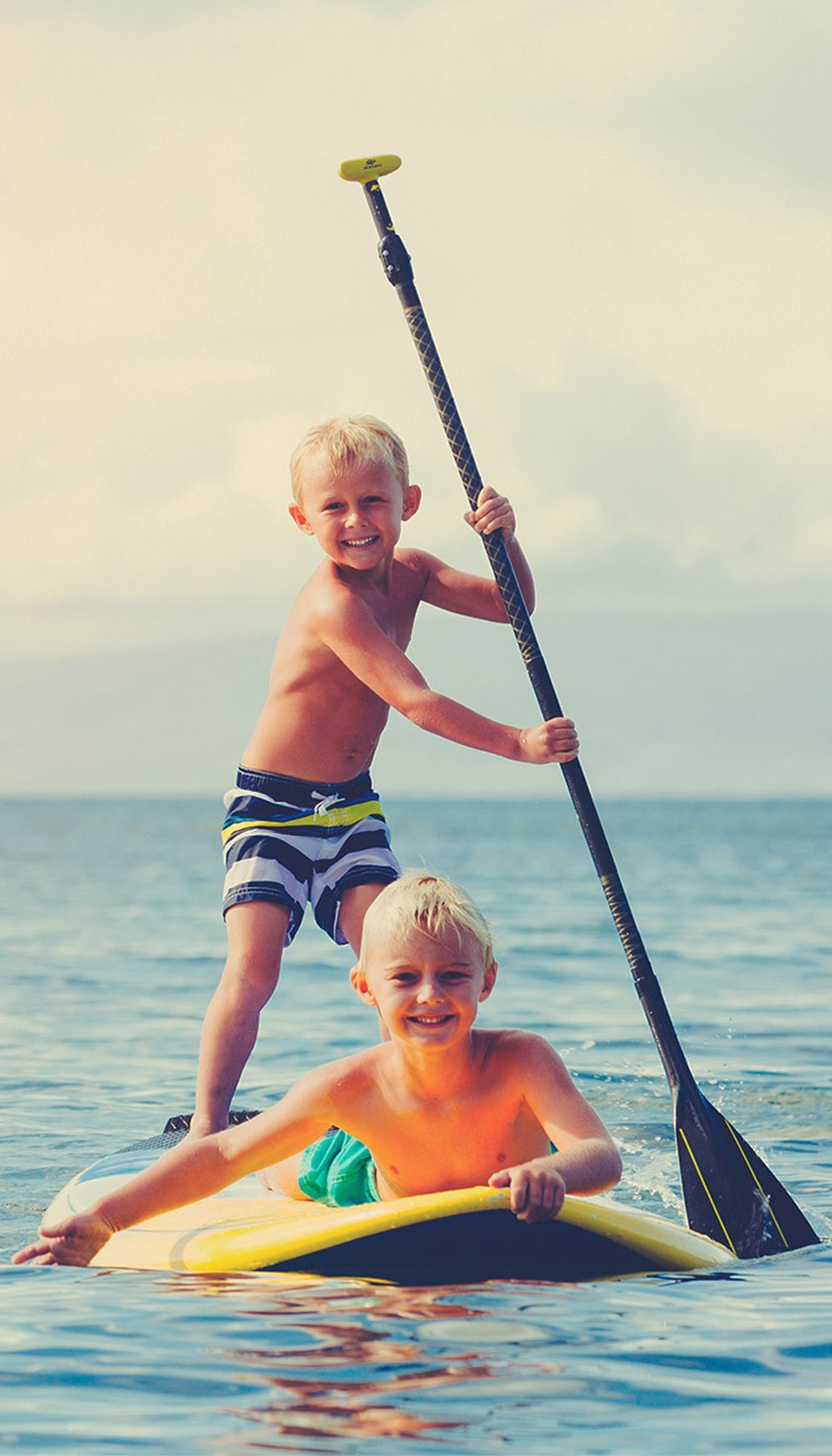 Brothers stand-up paddleboarding